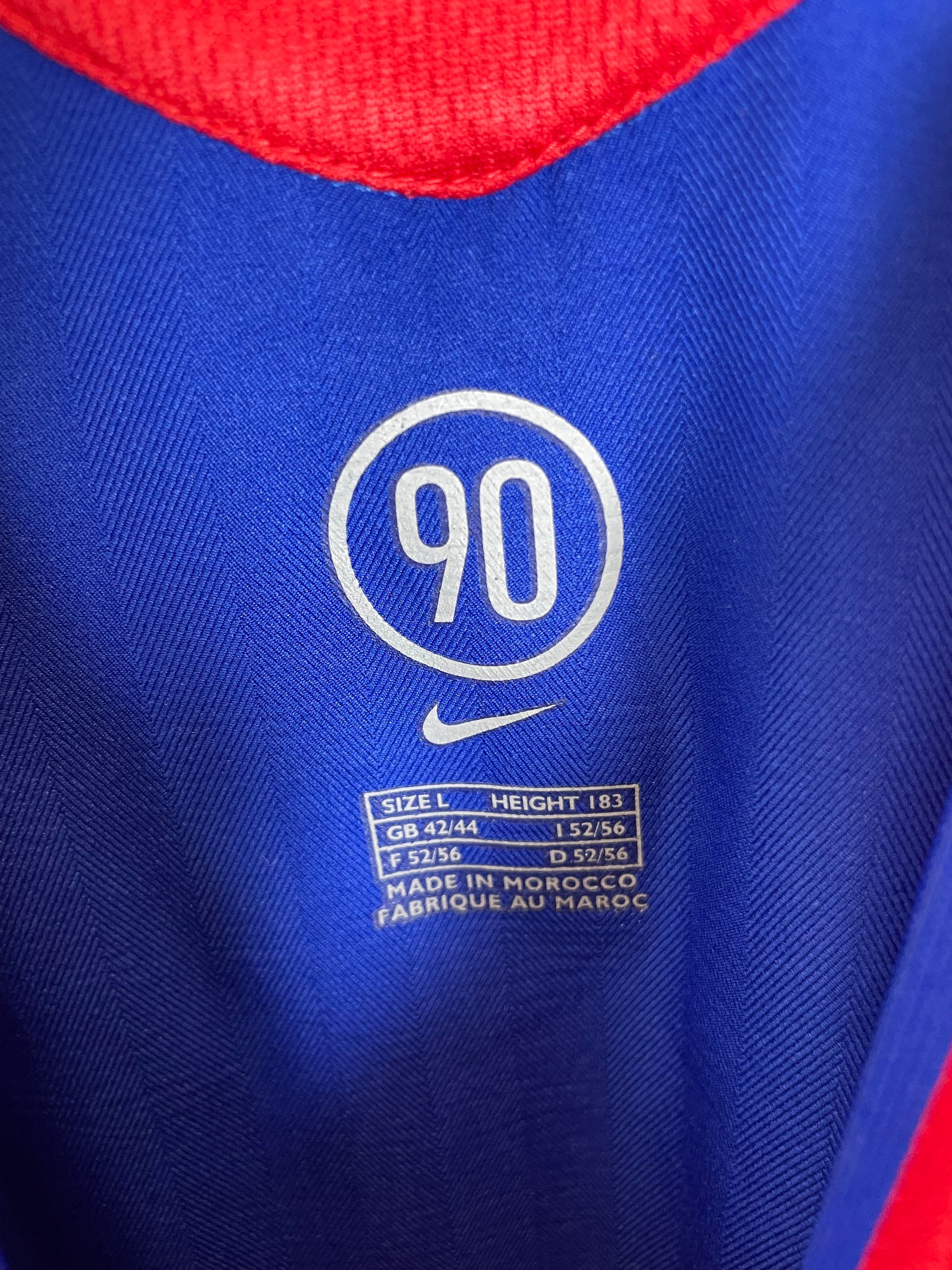Close-up of Manchester United club crest and Nike swoosh logo on white 05/06 away shirt