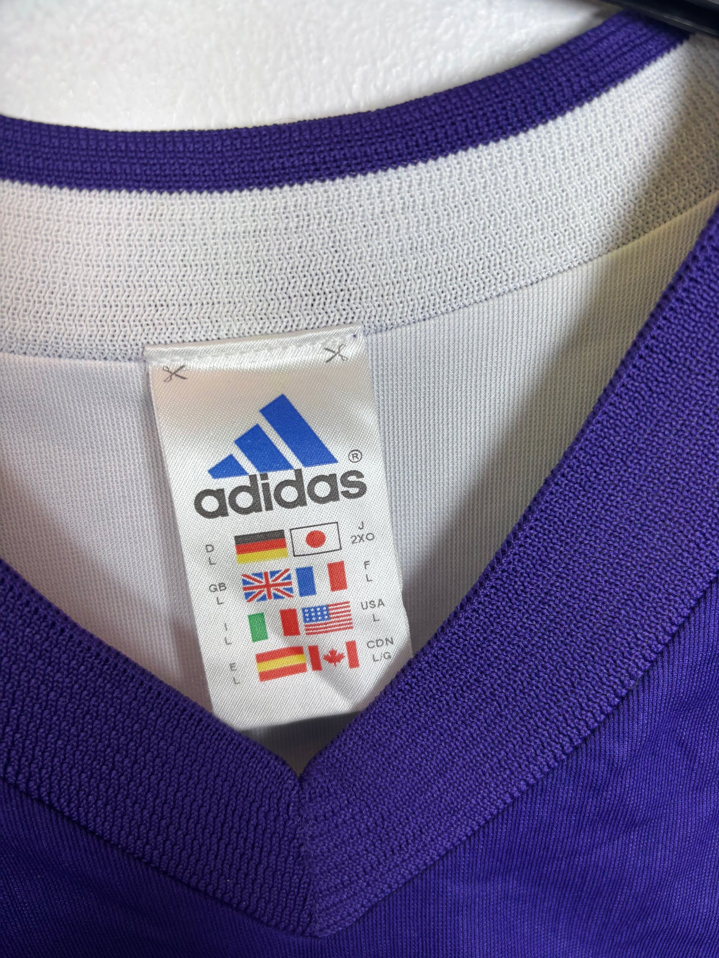 Close-up of Adidas logo and Real Madrid club badge on vintage 2002/03 third shirt