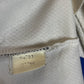 Close-up of a fabric texture with a visible label on a white background