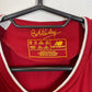 Close-up of New Balance logo and Liverpool club badge on red 19/20 home shirt