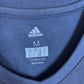 Close-up of Bayern Munich club badge and Adidas logo on white away shirt from 2017/18 season