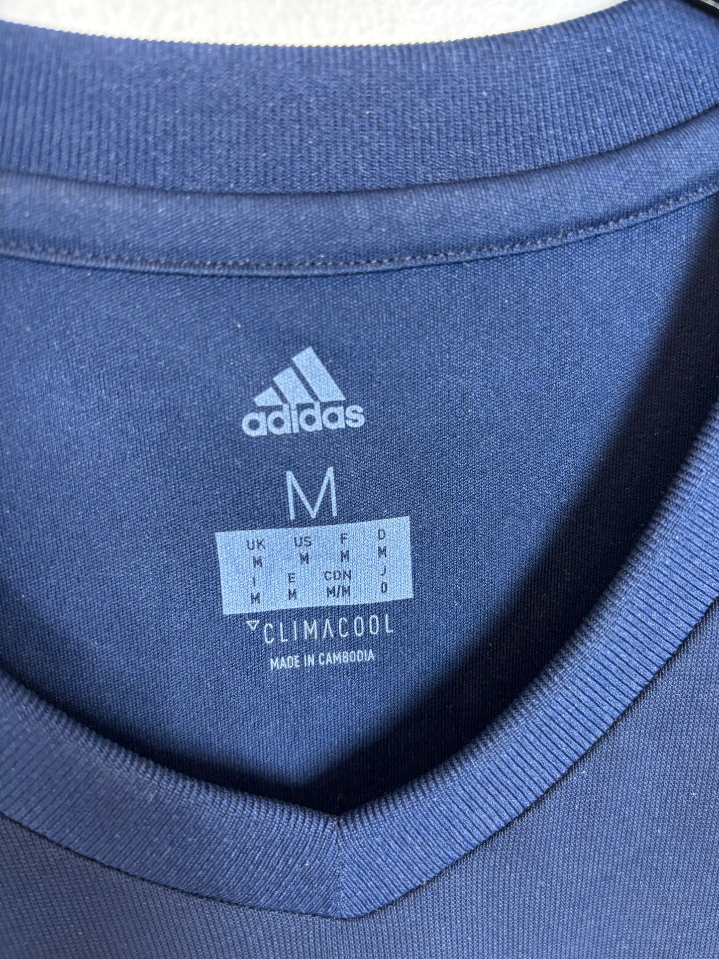 Close-up of Bayern Munich club badge and Adidas logo on white away shirt from 2017/18 season