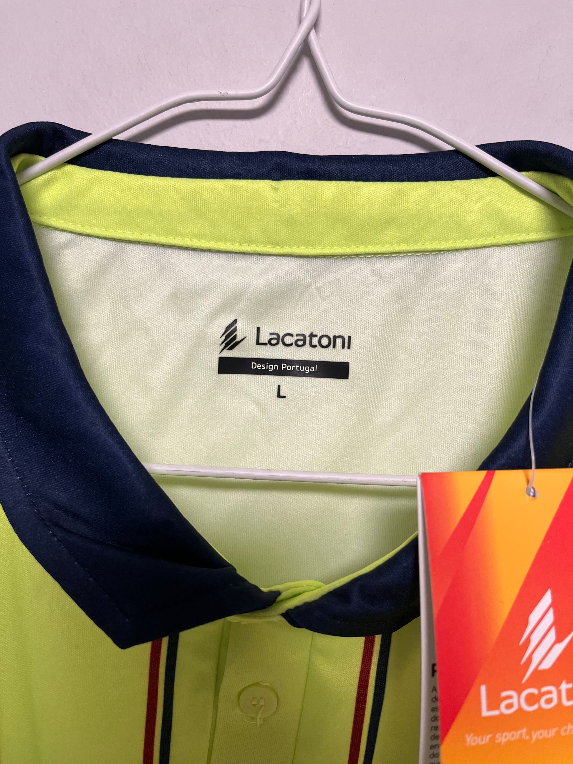 Navy and yellow shirt Deportivo de Chaves  with Lacoste branding on a light gray background