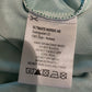Clothing label on a light blue fabric background