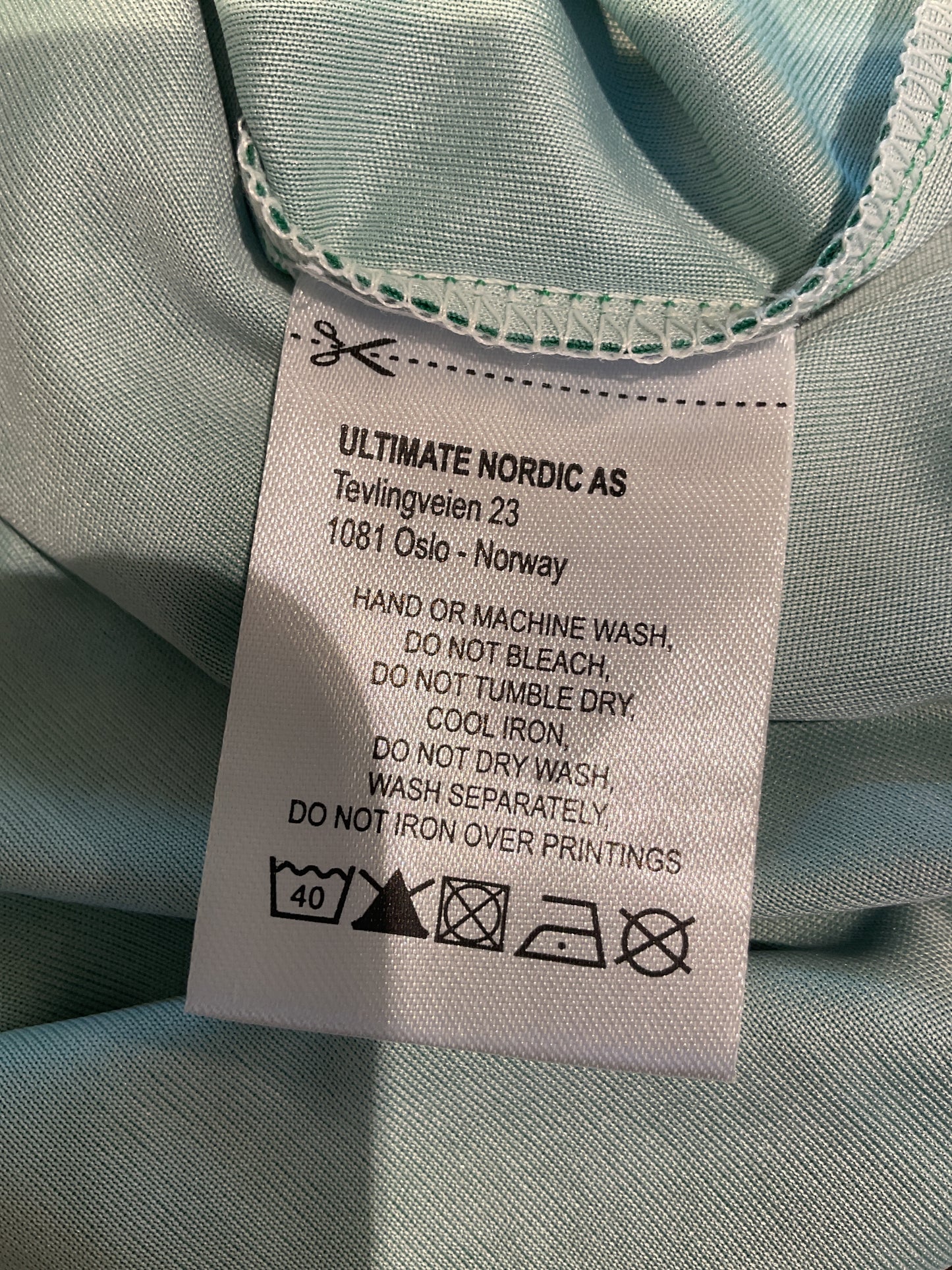 Clothing label on a light blue fabric background