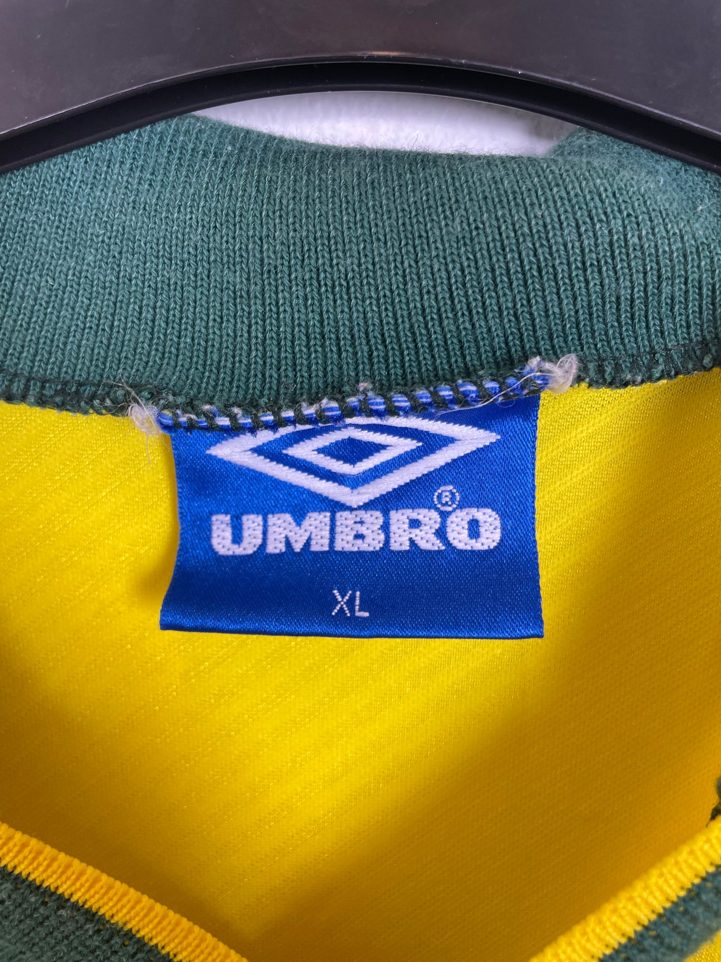 Close-up of Brazil national team badge and Umbro logo on 1993 yellow home football shirt