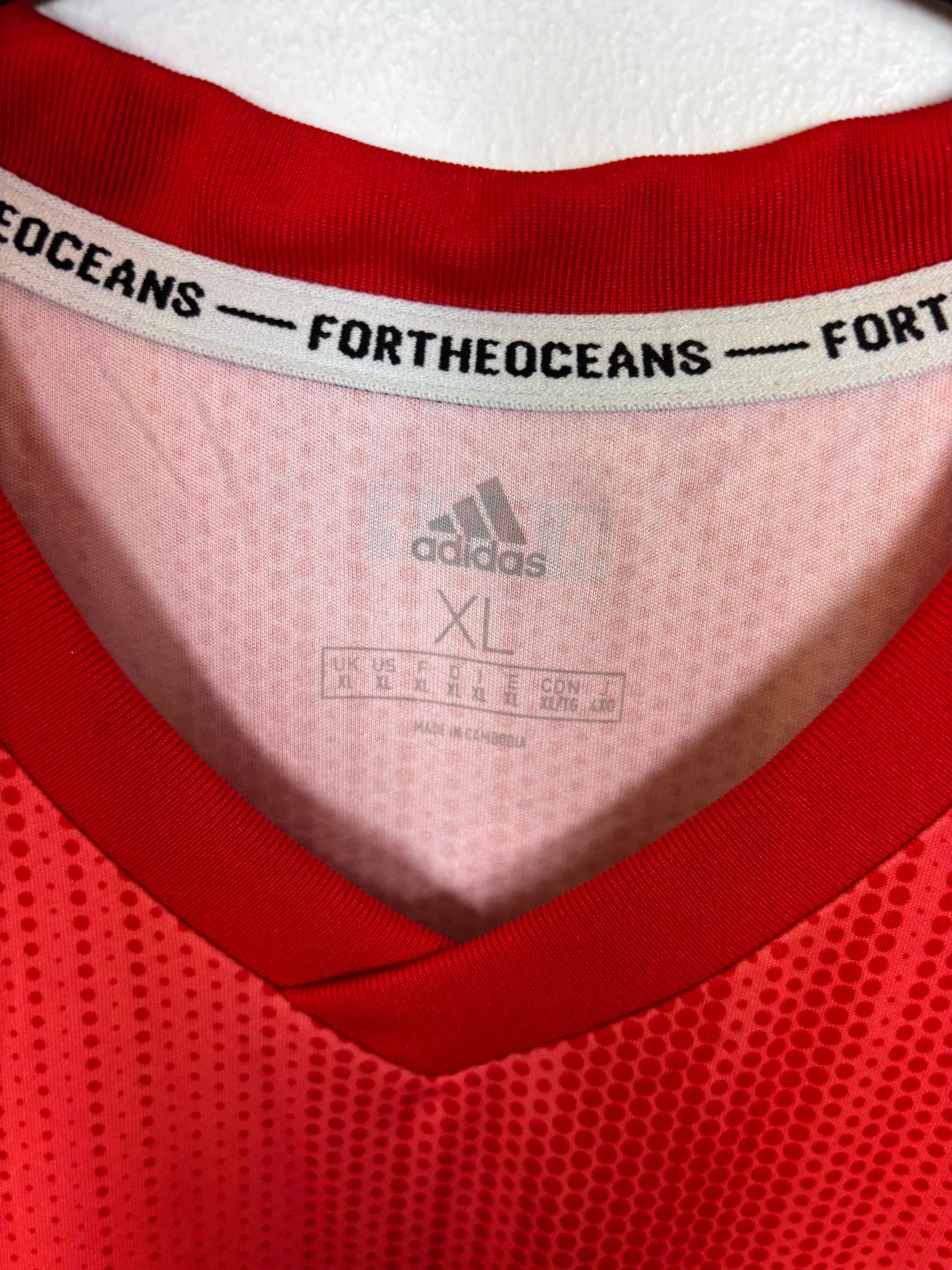 Close-up of Adidas logo and Real Madrid club badge on navy third shirt 18/19 season