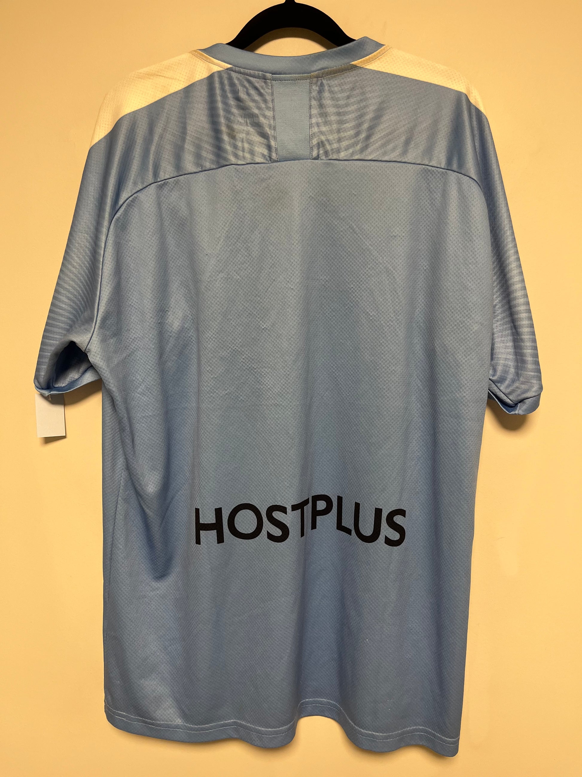 Gray shirt with 'HOSTPLUS' branding on a yellow background