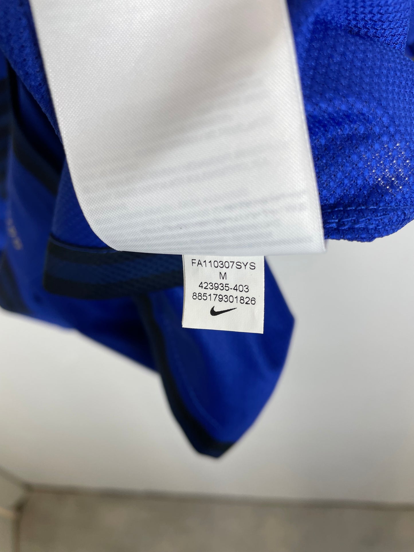 Nike swoosh logo and size tag detail on Manchester United 2011-13 away shirt collar area