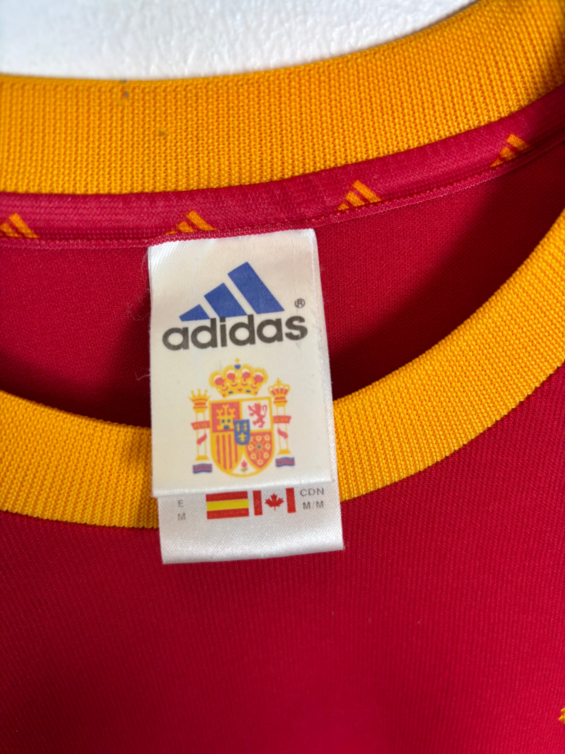 Close-up of Adidas logo and Spain national team crest on 2002 home shirt with Raul 7