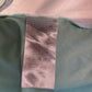 Close-up of a label on a green garment with a blurred background
