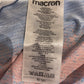Close-up of a Macron label on on shirt with text and symbols.