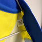 Close-up of a blue and yellow object with a visible label on a white background
