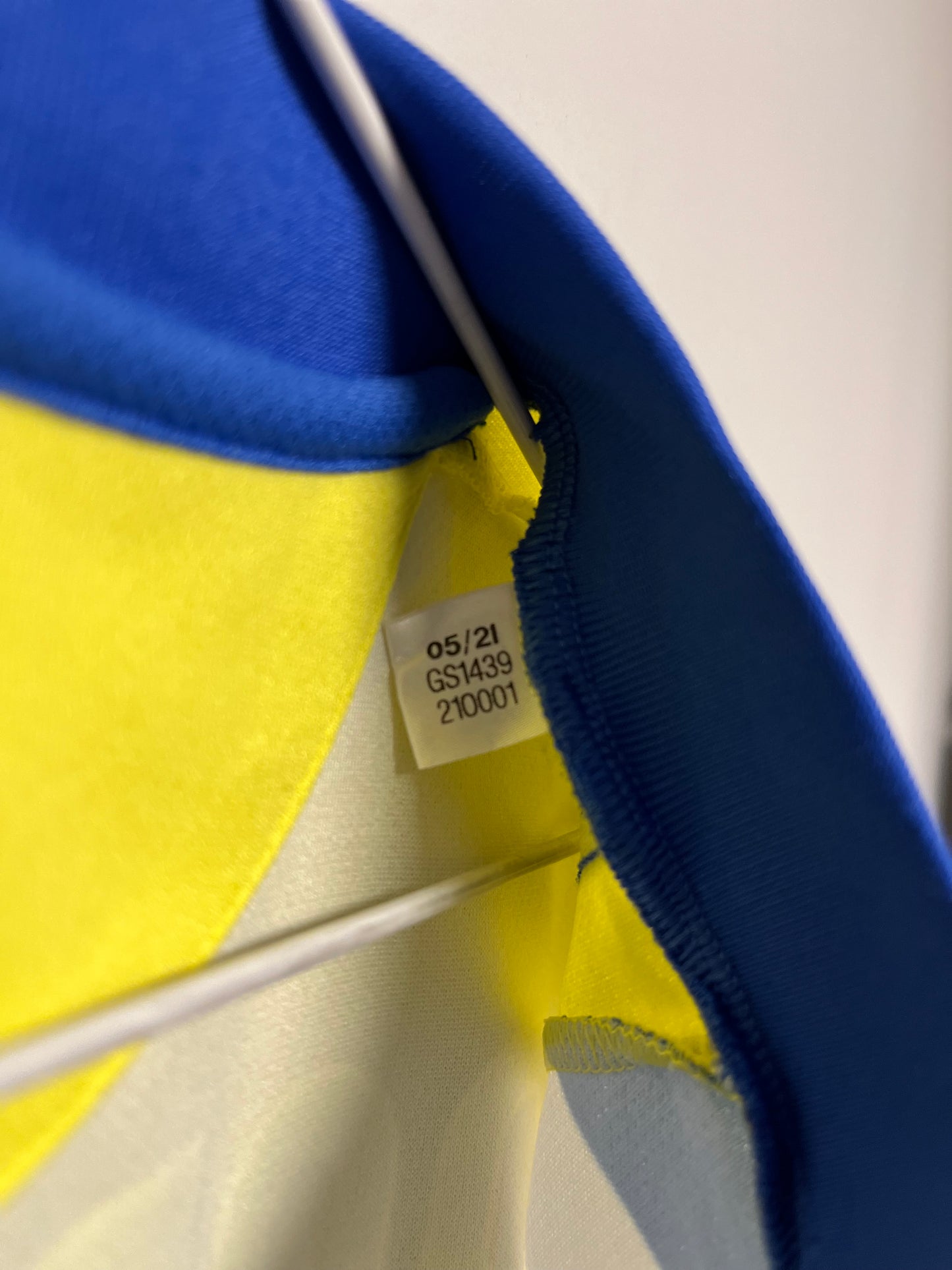 Close-up of a blue and yellow object with a visible label on a white background