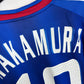 Close-up of Adidas trefoil logo and Japan Football Association crest on 2006 blue home shirt