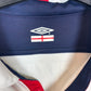 Close-up of Umbro logo and England Three Lions badge on white 03/05 home shirt