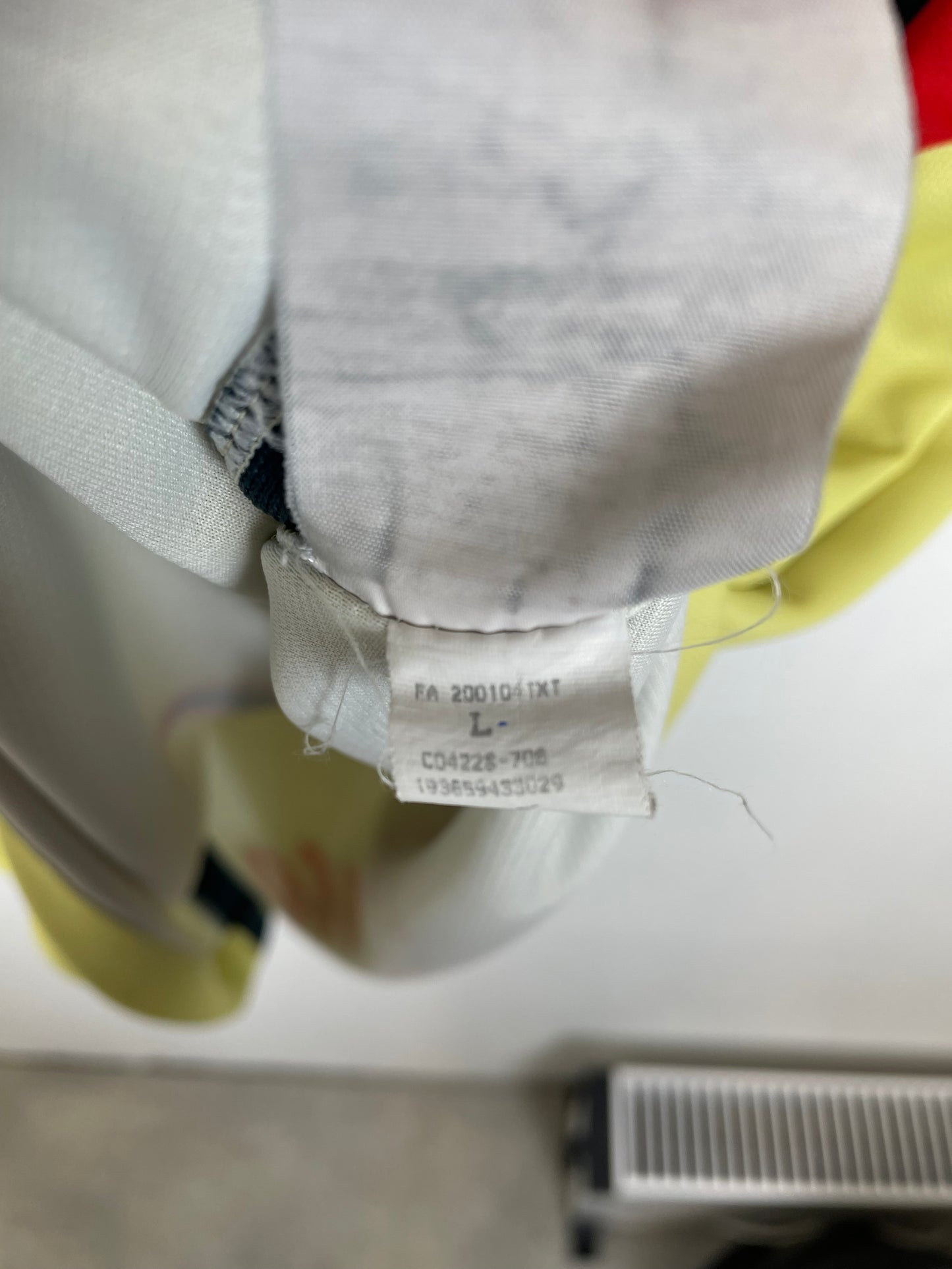 Nike size label and care instructions visible on Club América 20/21 yellow home shirt interior