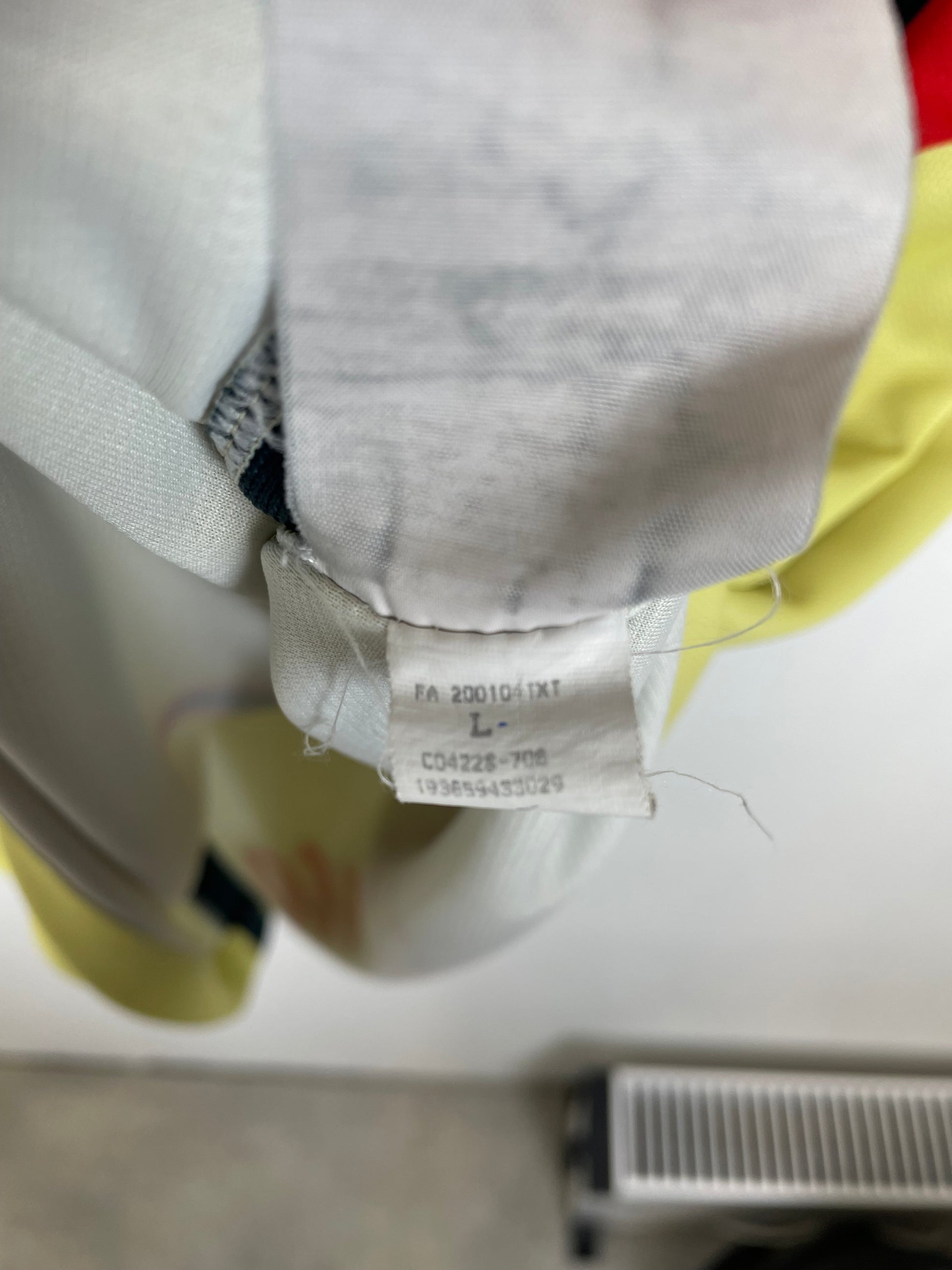Nike size label and care instructions visible on Club América 20/21 yellow home shirt interior