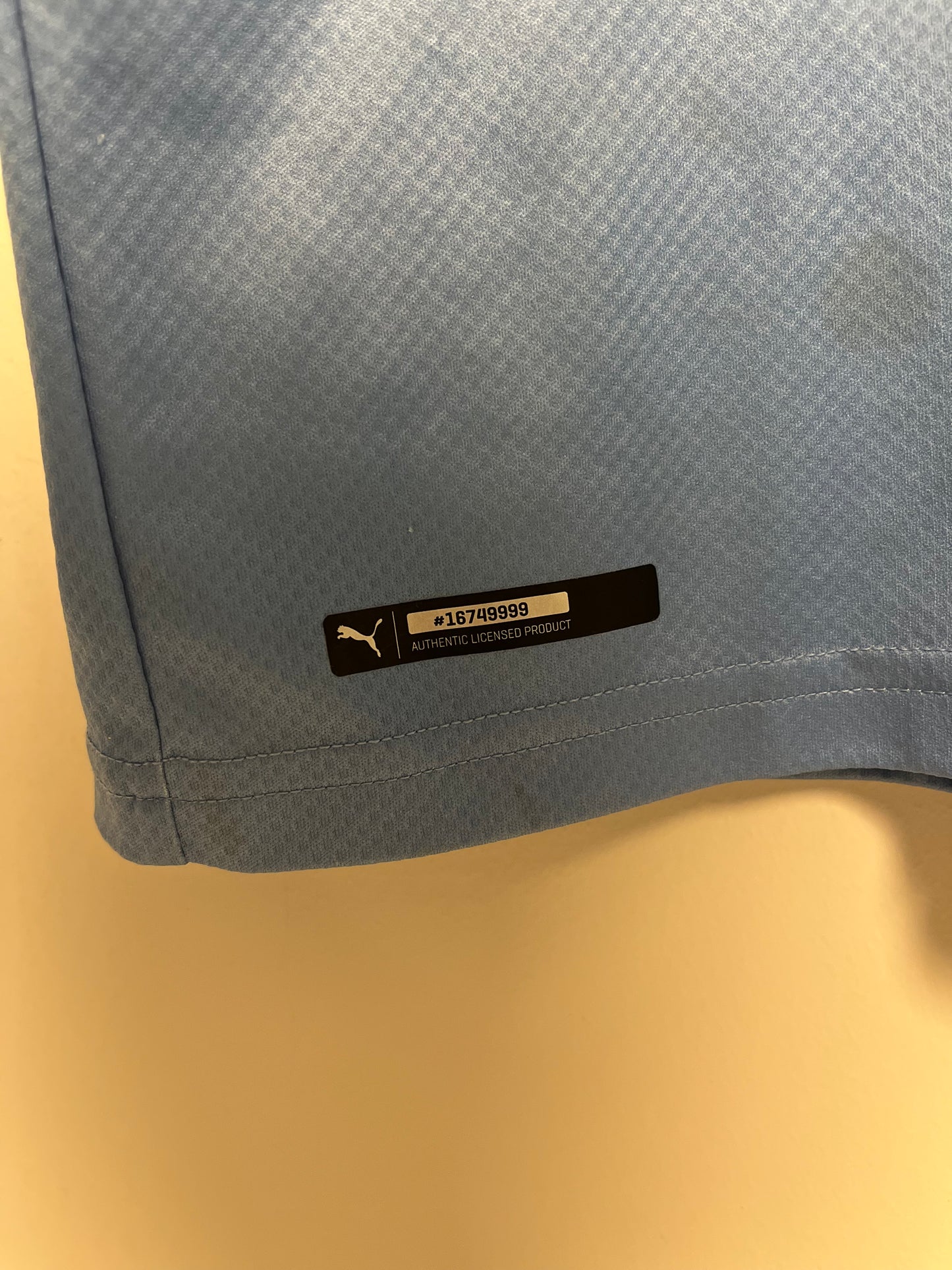 Gray fabric with a brand label on a beige background