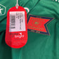 Green sports jersey with a brand tag and logo on a green background