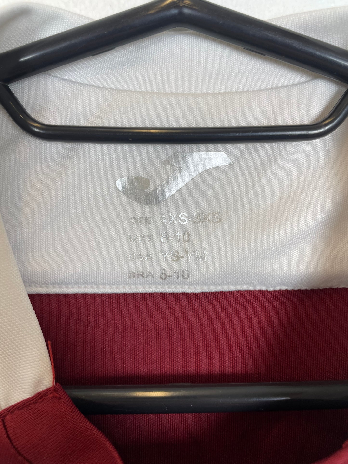 Close-up of Torino FC club badge and logo details on maroon 2022/23 training top for kids