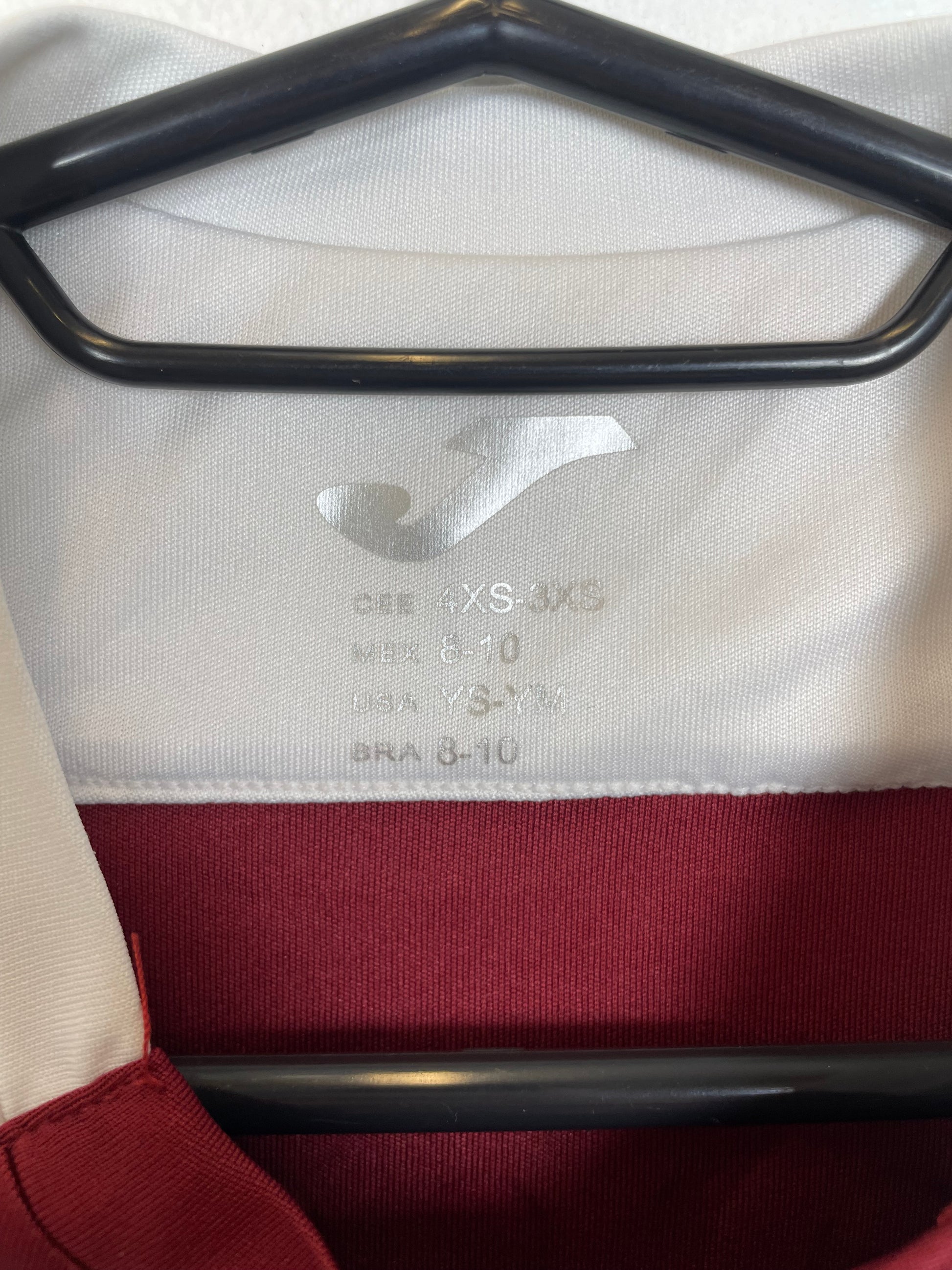 Close-up of Torino FC club badge and logo details on maroon 2022/23 training top for kids