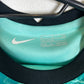 Close-up of Liverpool FC crest and Nike Swoosh logo on teal 2020/21 away kit