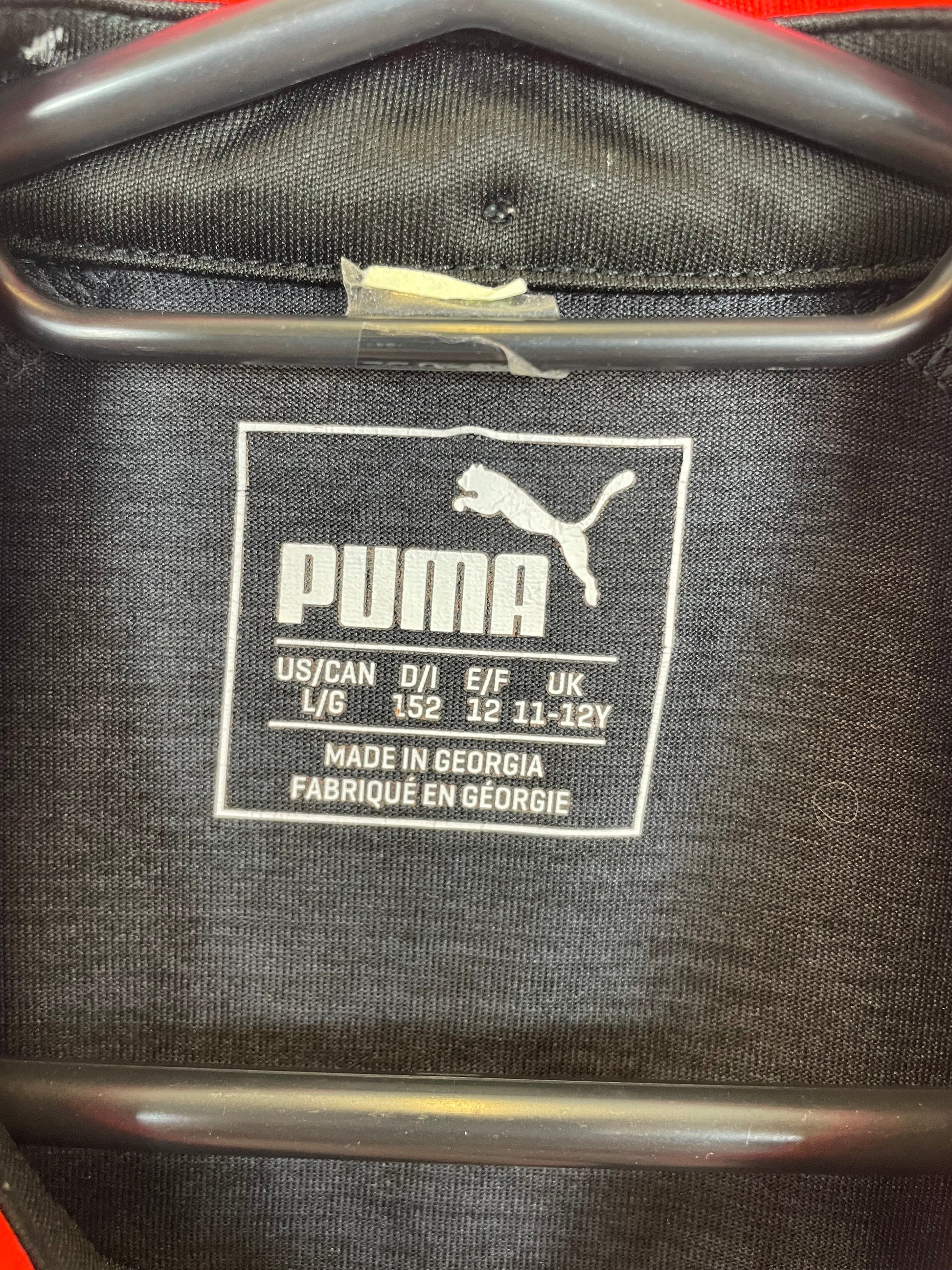 Close-up of Arsenal club badge and sponsor logo on navy blue third shirt 17/18 season