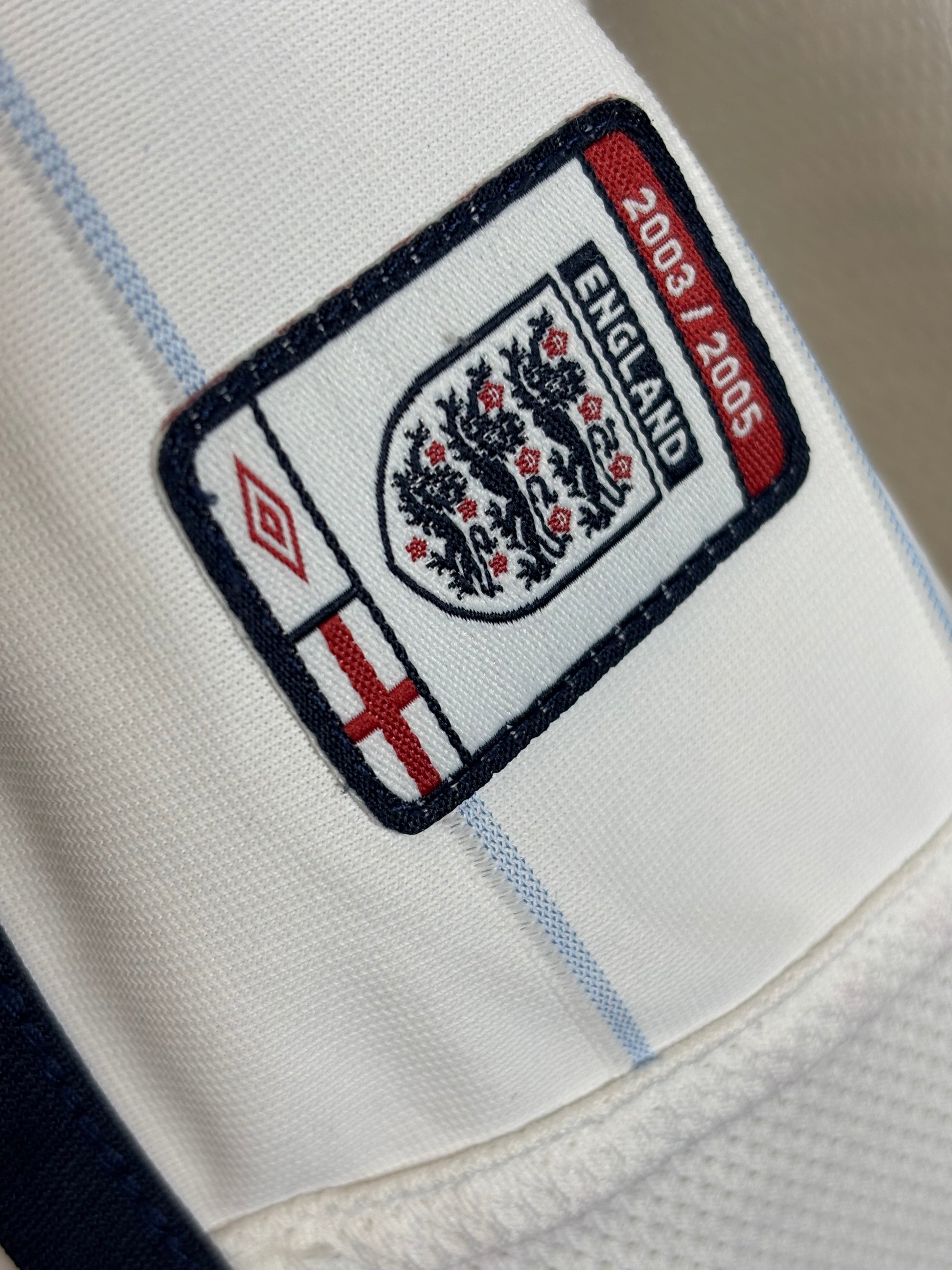Close-up of England 2003-05 home shirt fabric texture and Umbro construction details