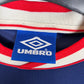 Close-up of Ajax club crest and Umbro logo details on 1999/2000 away football shirt