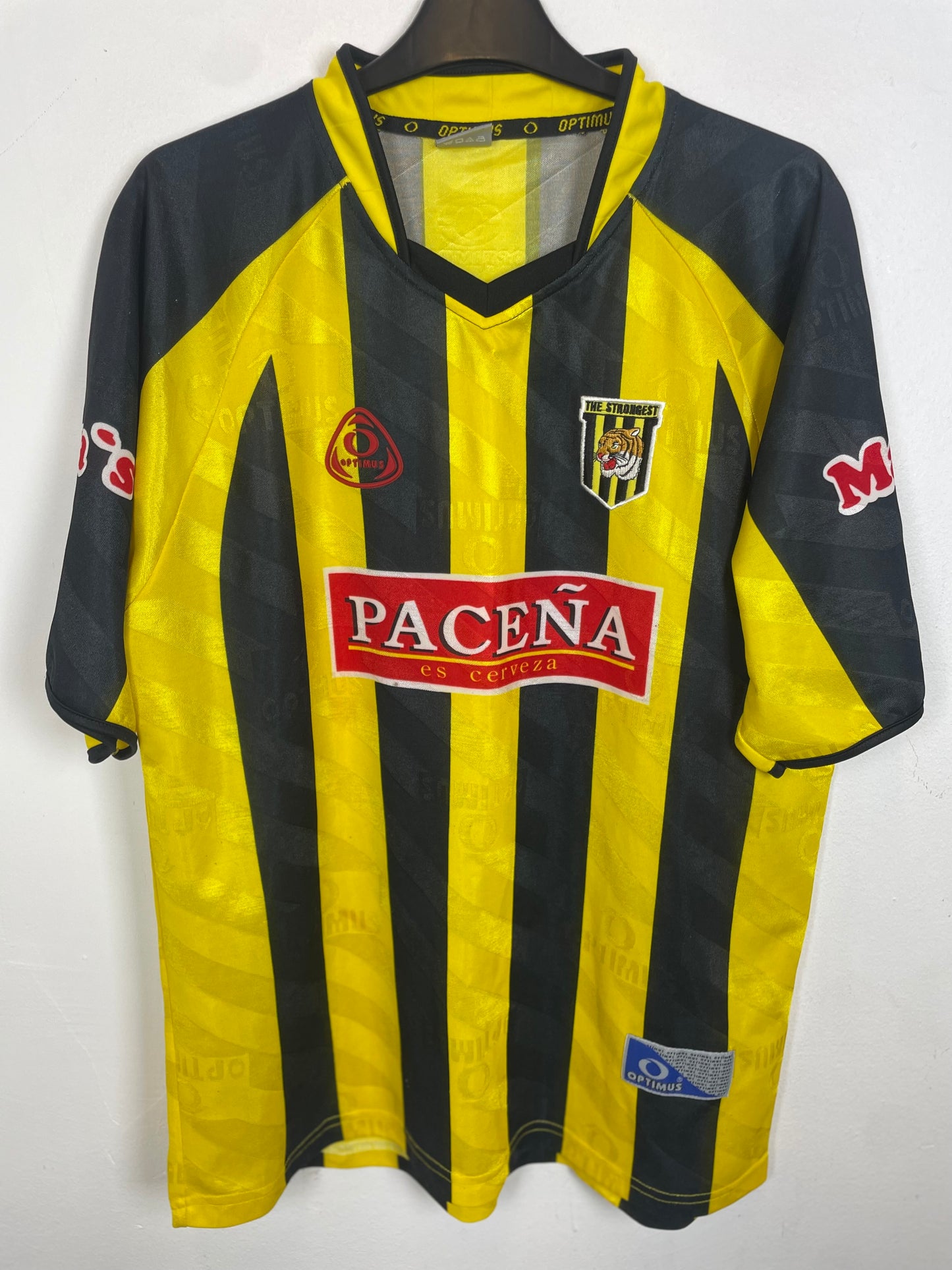 Optimus The Strongest Bolivia home shirt — front view in yellow and black Chayñita stripes