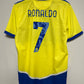 Yellow sports jersey with 'RONALDO' and number '7' on a hanger against a gray background