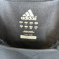 Close-up of the interior lining of a black Adidas bag, showing the white Adidas logo, size information, and a beige CLIMAWA 350 label.
