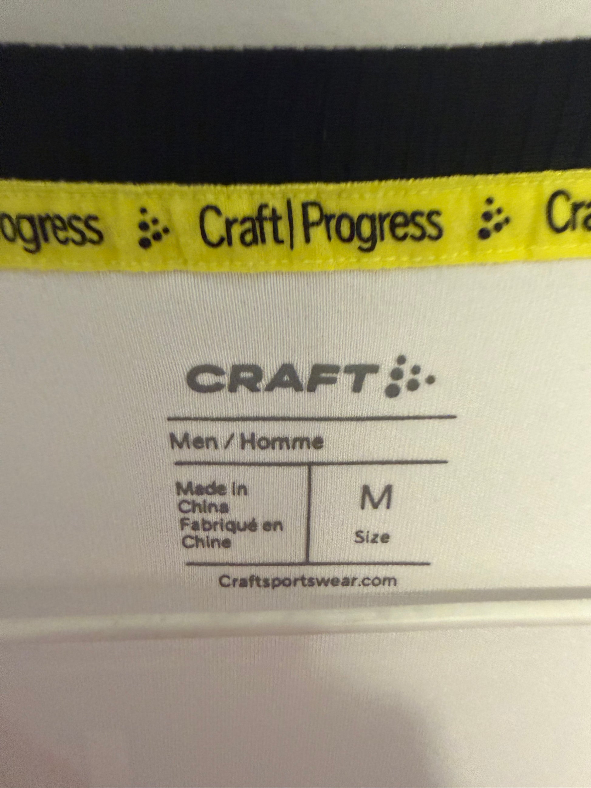 Close-up of Craft logo and Åsane Fotball club badge details on 2025 white away shirt