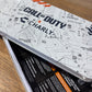 Phone case with 'Call of Duty' design on a wooden surface
