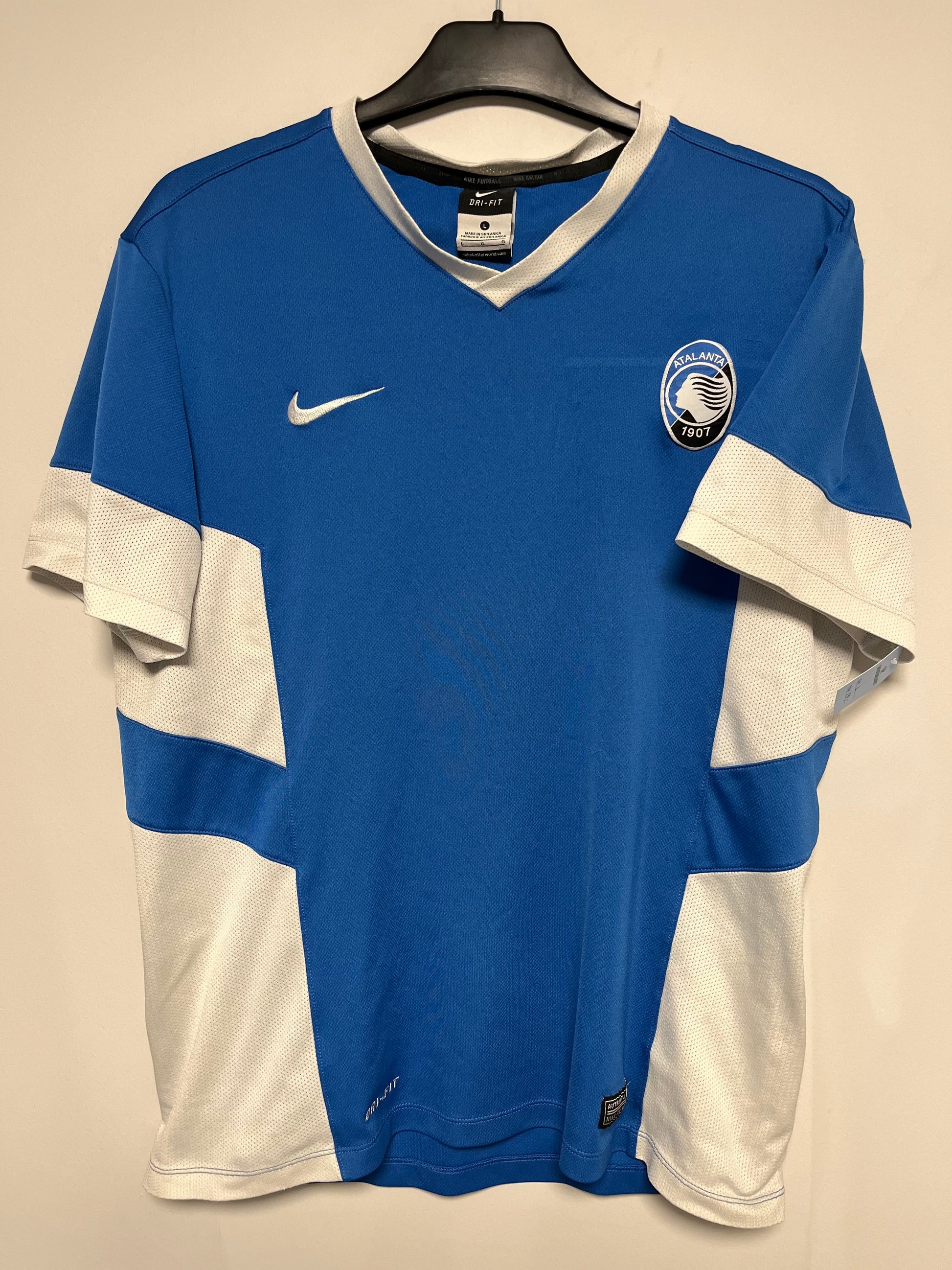 Nike Atlanta training shirt  with Nike logo on a beige background