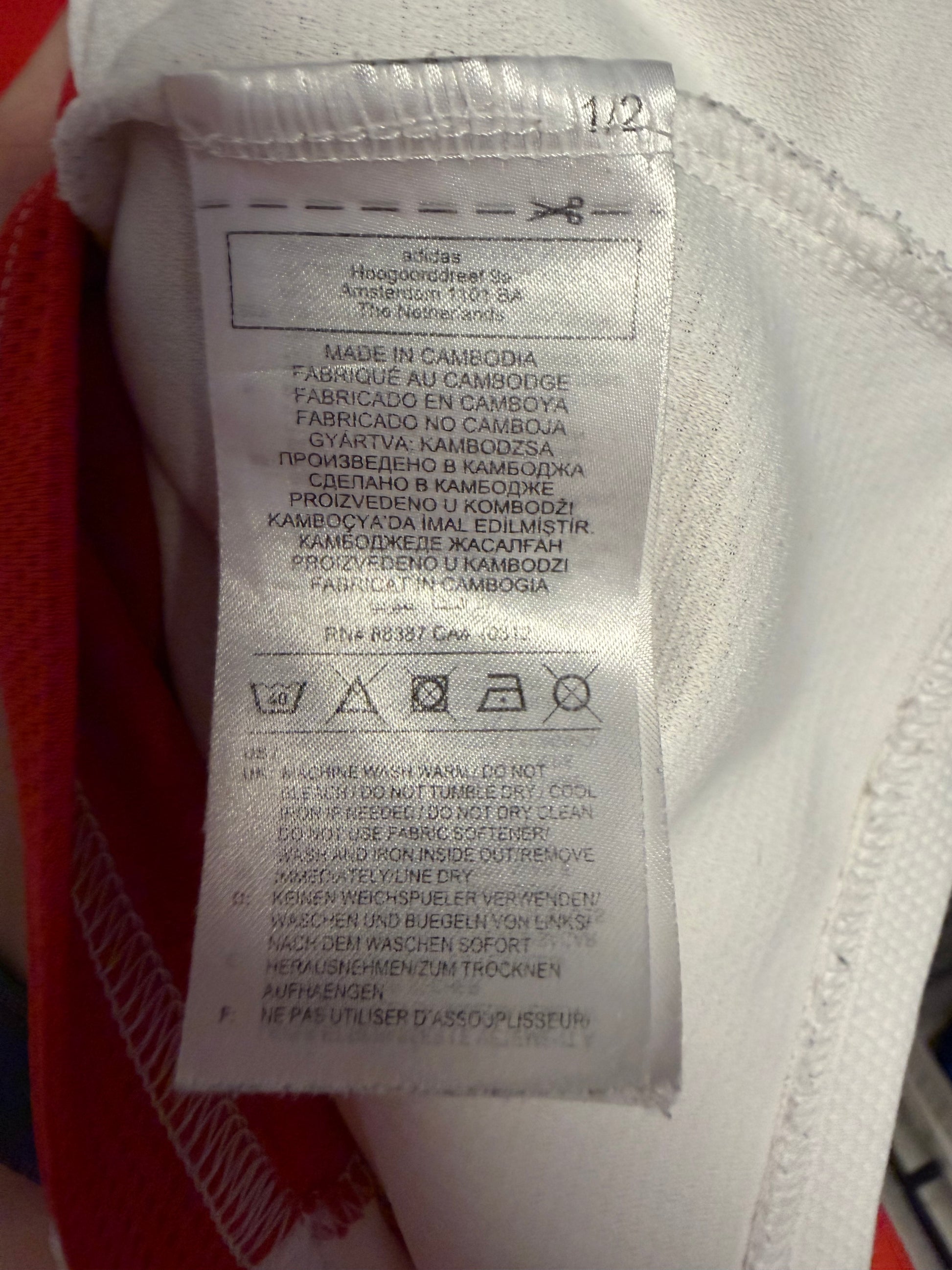 Interior size label and care instructions of Adidas Ajax 21/22 Haller home jersey