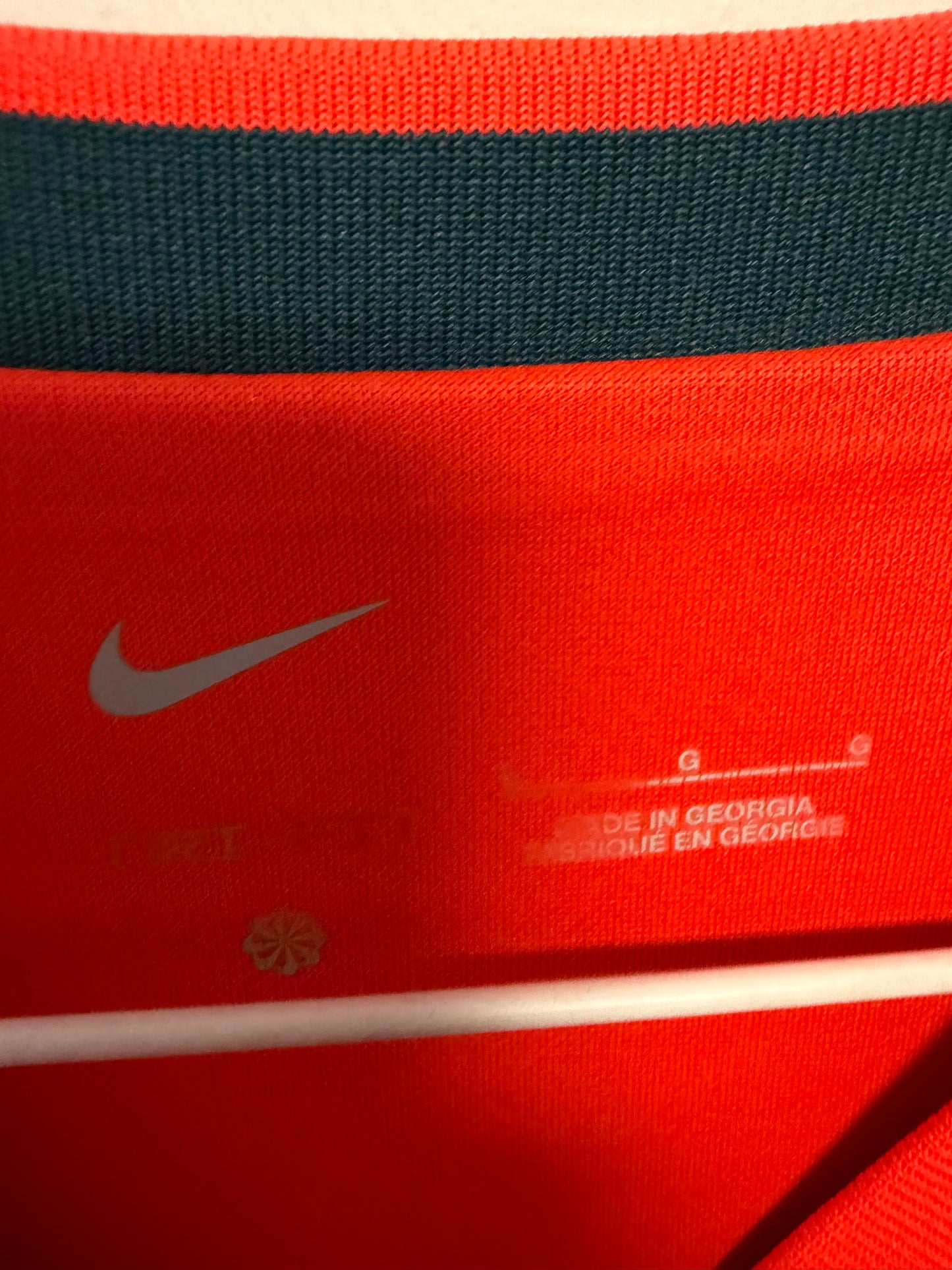 Close-up detail of Liverpool FC club crest and Nike swoosh on 2021/22 Henderson home shirt