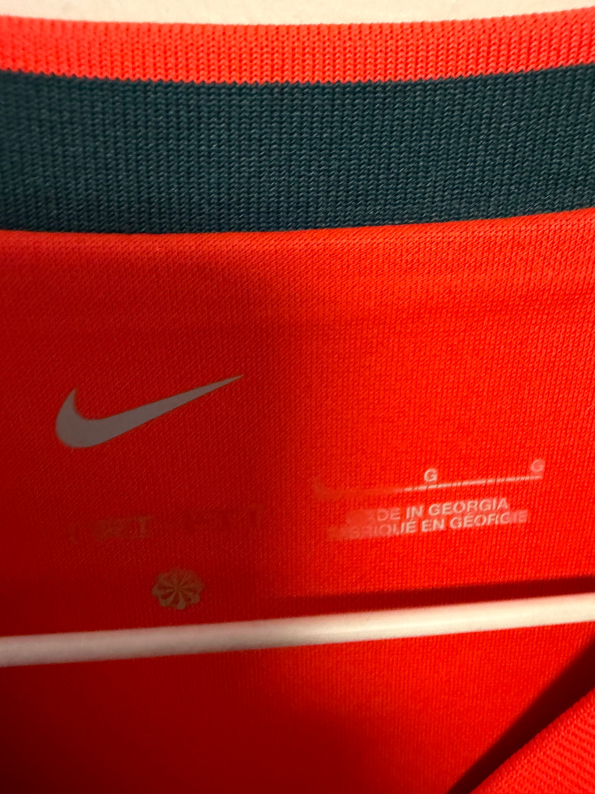 Close-up detail of Liverpool FC club crest and Nike swoosh on 2021/22 Henderson home shirt