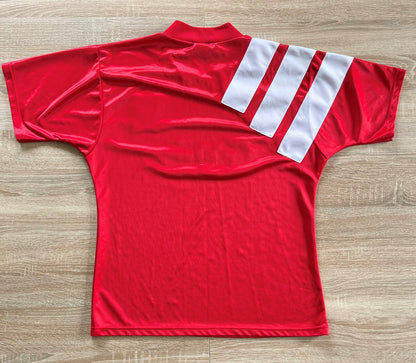 Liverpool Home Shirt from 1992-1993: The iconic home jersey worn by Liverpool during the 1992-1993 season. Featuring the club's emblem and a classic design, this shirt encapsulates the team's history and performances during that memorable period