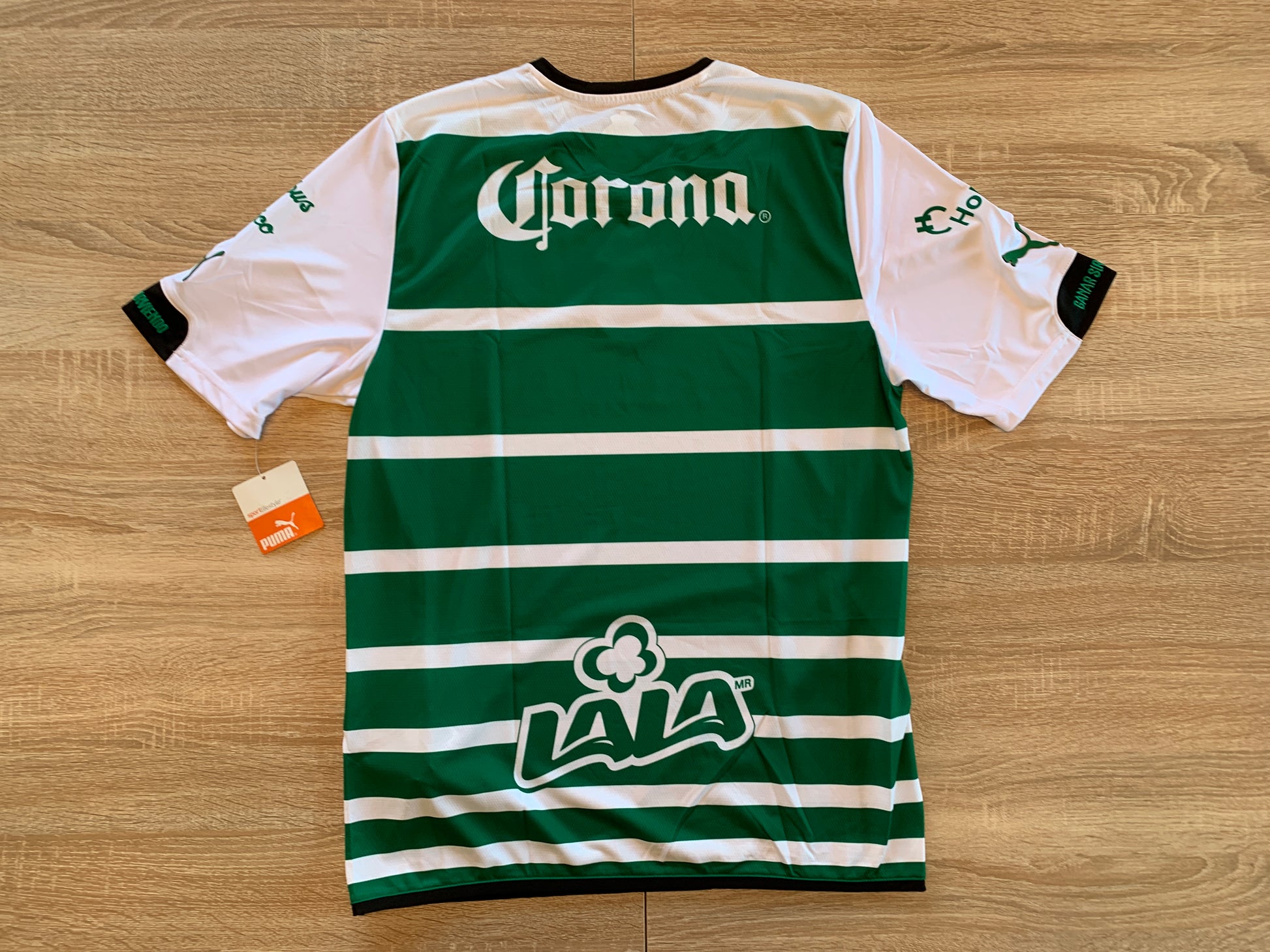 Club Santos Laguna Home Shirt from 2014-2015: Experience the sleek and stylish Slim Fit version of this iconic green and white striped jersey. Show your unwavering support for Los Guerreros and be a part of Santos Laguna's football journey. Order now to represent your club with flair