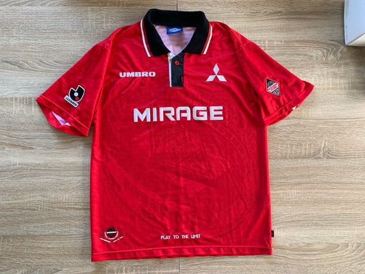 Urawa Red Diamonds Home Shirt from 1997: The iconic home jersey worn by Urawa Red Diamonds during the 1997 season. Featuring the club's emblem, it signifies a memorable era in the team's history and the dedication of their fans.
