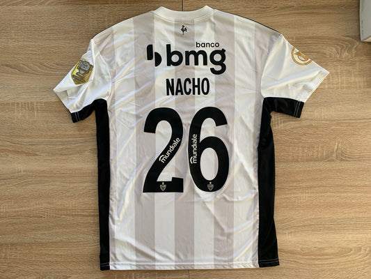 Athletico Mineiro Home Shirt from 2022-2023: Worn by Nacho, this jersey represents Clube Atlético Mineiro's home kit for the 2022-2023 season. Featuring the club's emblem, it symbolizes the team's identity and Nacho's presence on the field.