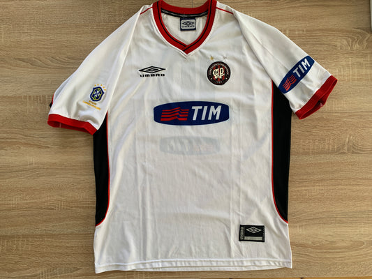 Athletico Paranaense Away Shirt from 2001: The away jersey worn by Athletico Paranaense during the 2001 season. With its unique design, it represents the club's spirit and style on the field during that specific period.