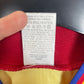 Close-up of the Romania national team crest on the original 1996 yellow home shirt, detail shot from our store