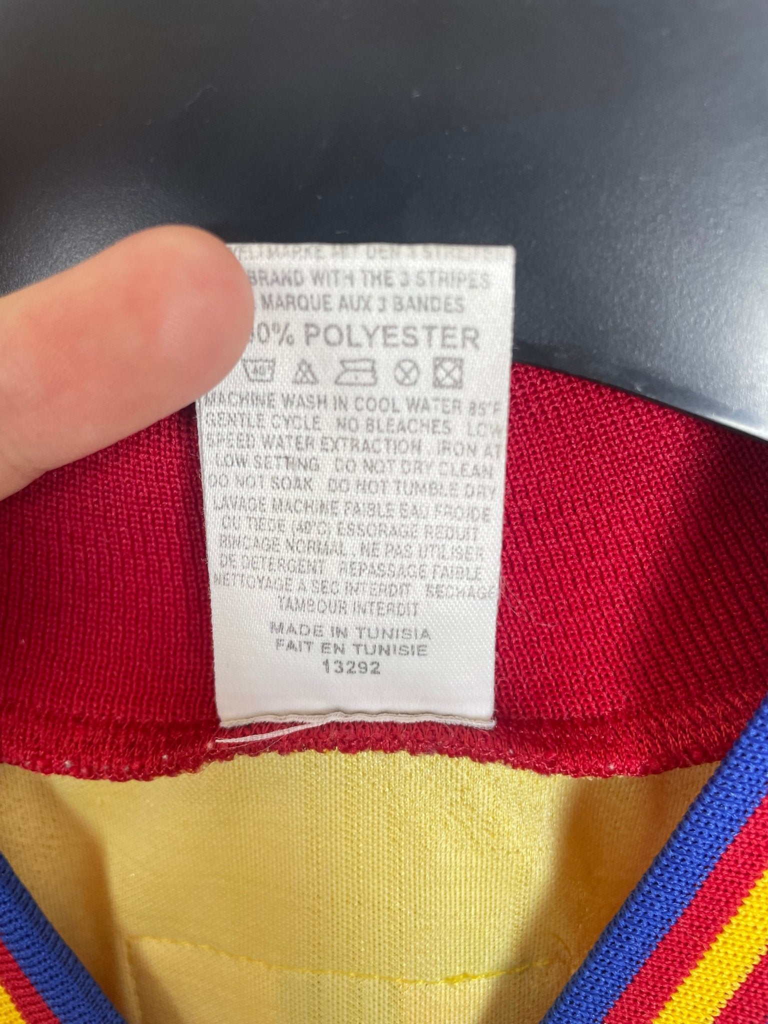 Close-up of the Romania national team crest on the original 1996 yellow home shirt, detail shot from our store