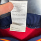 Close-up of the Spain national team crest on the original 1998 red home football shirt, detail shot from our store