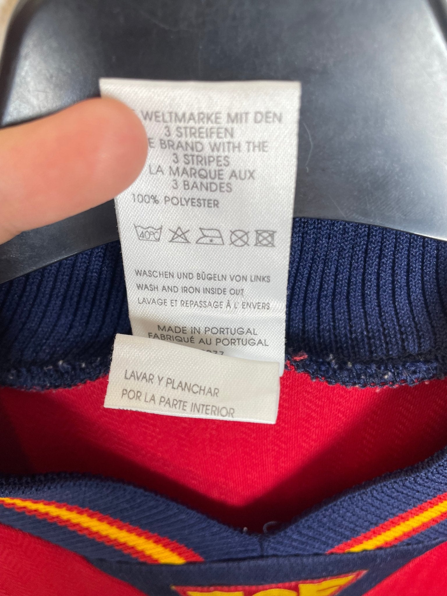 Close-up of the Spain national team crest on the original 1998 red home football shirt, detail shot from our store