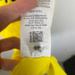 Close-up of the Norwich City club crest on the 20/21 canary yellow home football shirt, detail shot from our store