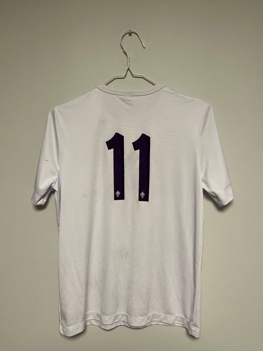 Front view of the Fiorentina 19/20 kids away shirt showing the La Viola badge and sponsor, shown in full front detail